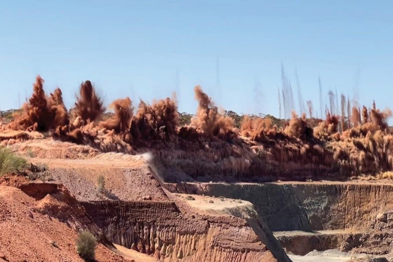 An open pit blast in progress at a mining operation