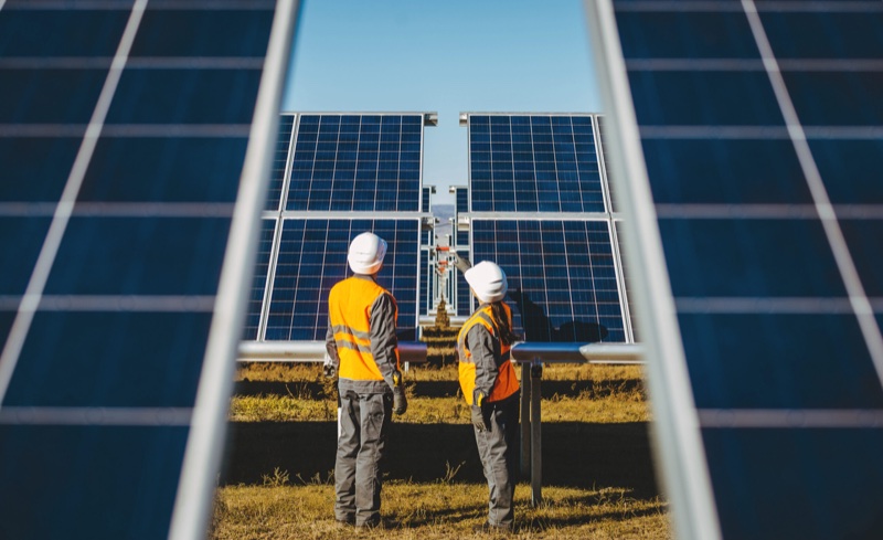 Workers inspecting panels at a solar farm, imagery from the Sabre Engineering website